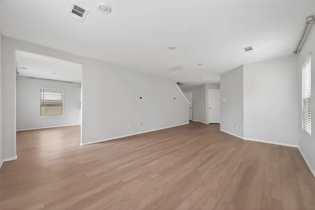 a view of empty room with wooden floor and cabinet