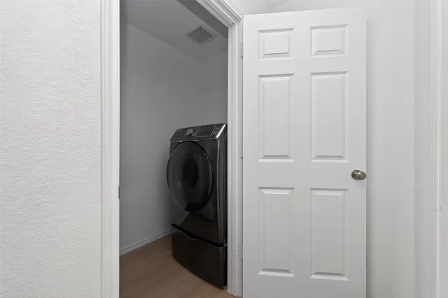 a view of walk in closet with clothes