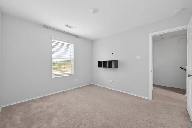 an empty room with windows and closet