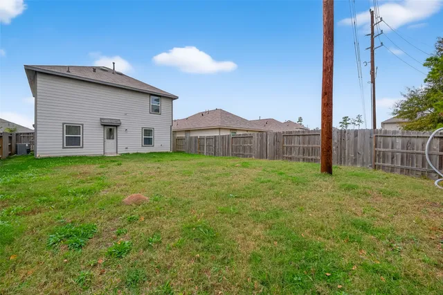 a view of a house with a yard and sitting area