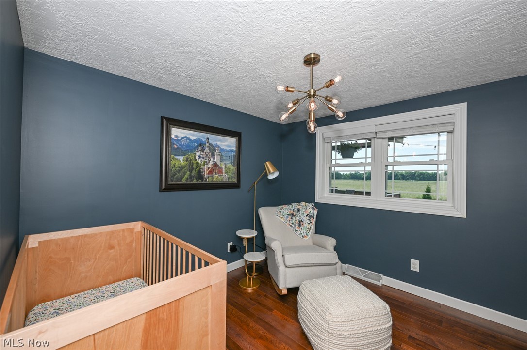 5803 Doylestown Road Seville, OH 44273 - Photo 16 of 37 Bedroom 3 featuring hickory hardwood flooring and chandelier