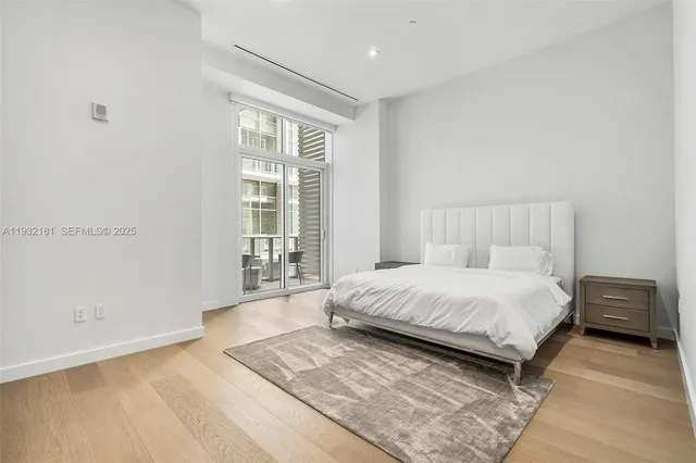 a bedroom with a large bed and a window