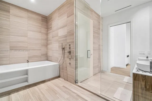 a bathroom with a bathtub and a shower