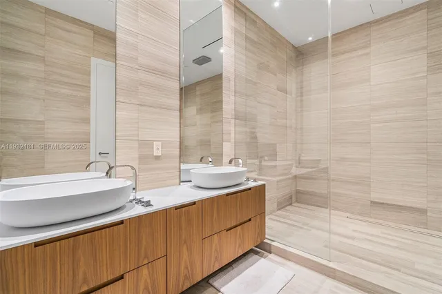 a bathroom with a double vanity sink and mirror