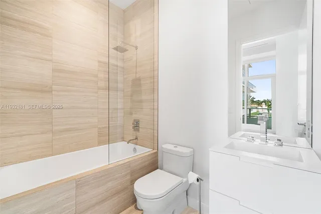 a bathroom with a sink a toilet and bathtub