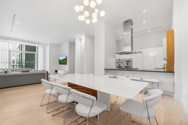 a kitchen with a dining table chairs and a sink