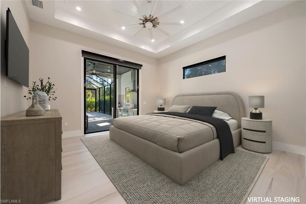 662 9th Street Southwest Naples, FL 34117 - Photo 17 of 34 a bedroom with a large bed and a flat screen tv