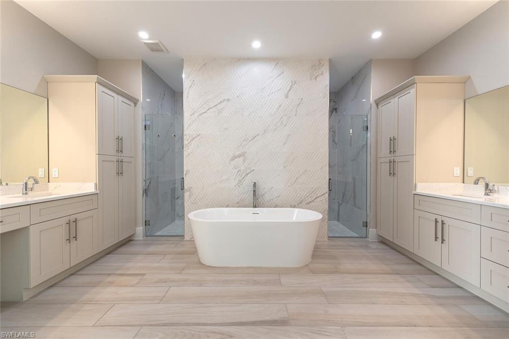 662 9th Street Southwest Naples, FL 34117 - Photo 19 of 34 a spacious bathroom with a bathtub sink and mirror