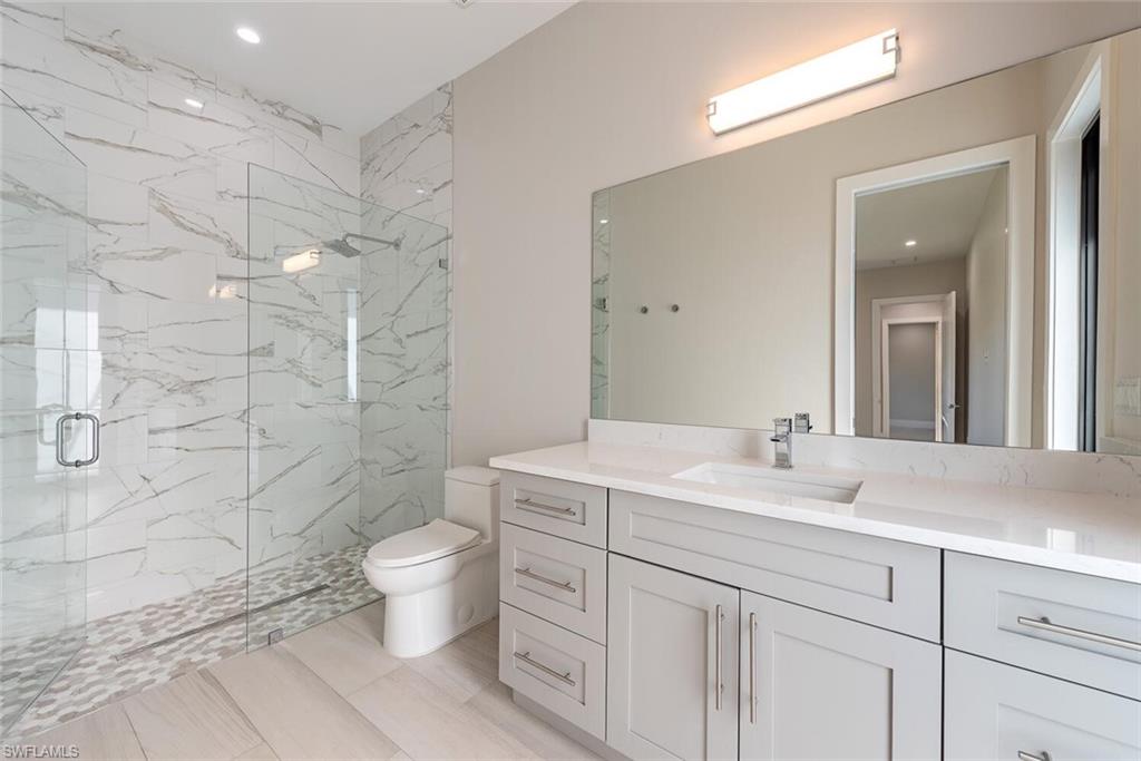 662 9th Street Southwest Naples, FL 34117 - Photo 23 of 34 a bathroom with a double vanity sink toilet and shower
