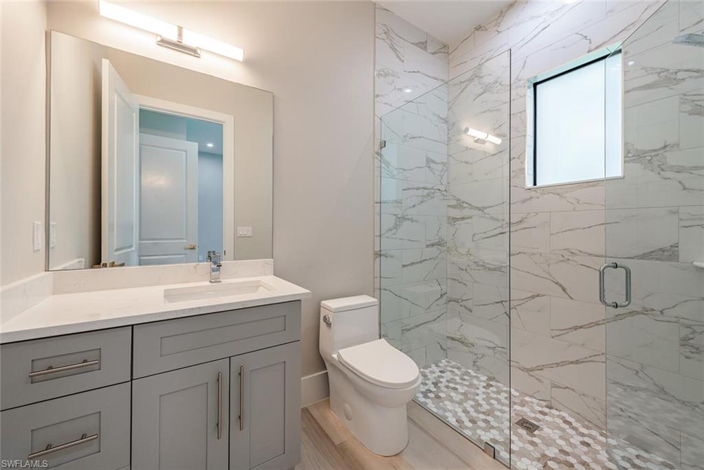 662 9th Street Southwest Naples, FL 34117 - Photo 27 of 34 a bathroom with a sink a toilet and shower