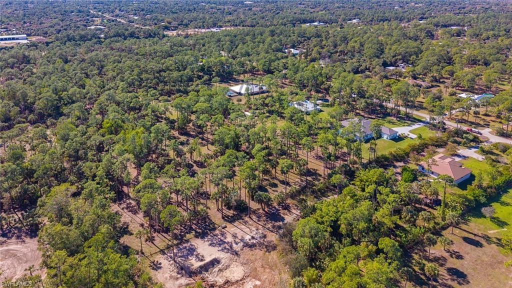 662 9th Street Southwest Naples, FL 34117 - Photo 34 of 34 a view of a house with a lush green forest