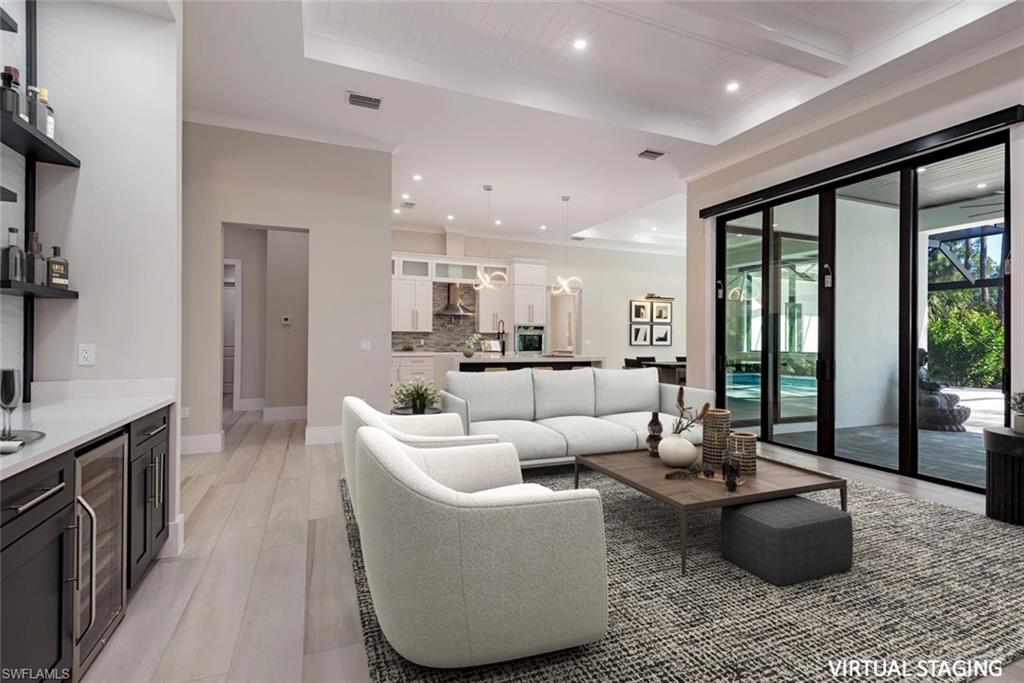 662 9th Street Southwest Naples, FL 34117 - Photo 4 of 34 a living room with furniture and large windows