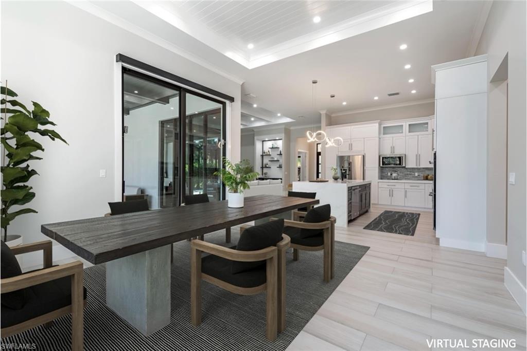 662 9th Street Southwest Naples, FL 34117 - Photo 9 of 34 a kitchen with a table and chairs in it