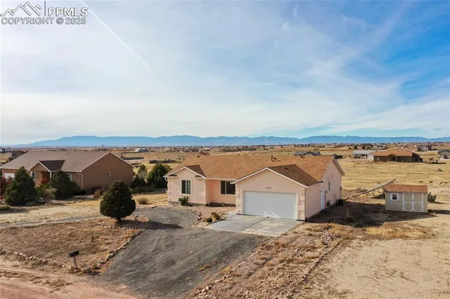 an aerial view of a house with a yard