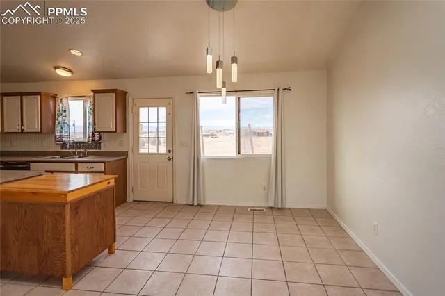 a kitchen with a stove a sink and a refrigerator