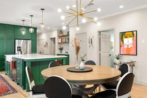 a kitchen with kitchen island a sink stove and cabinets