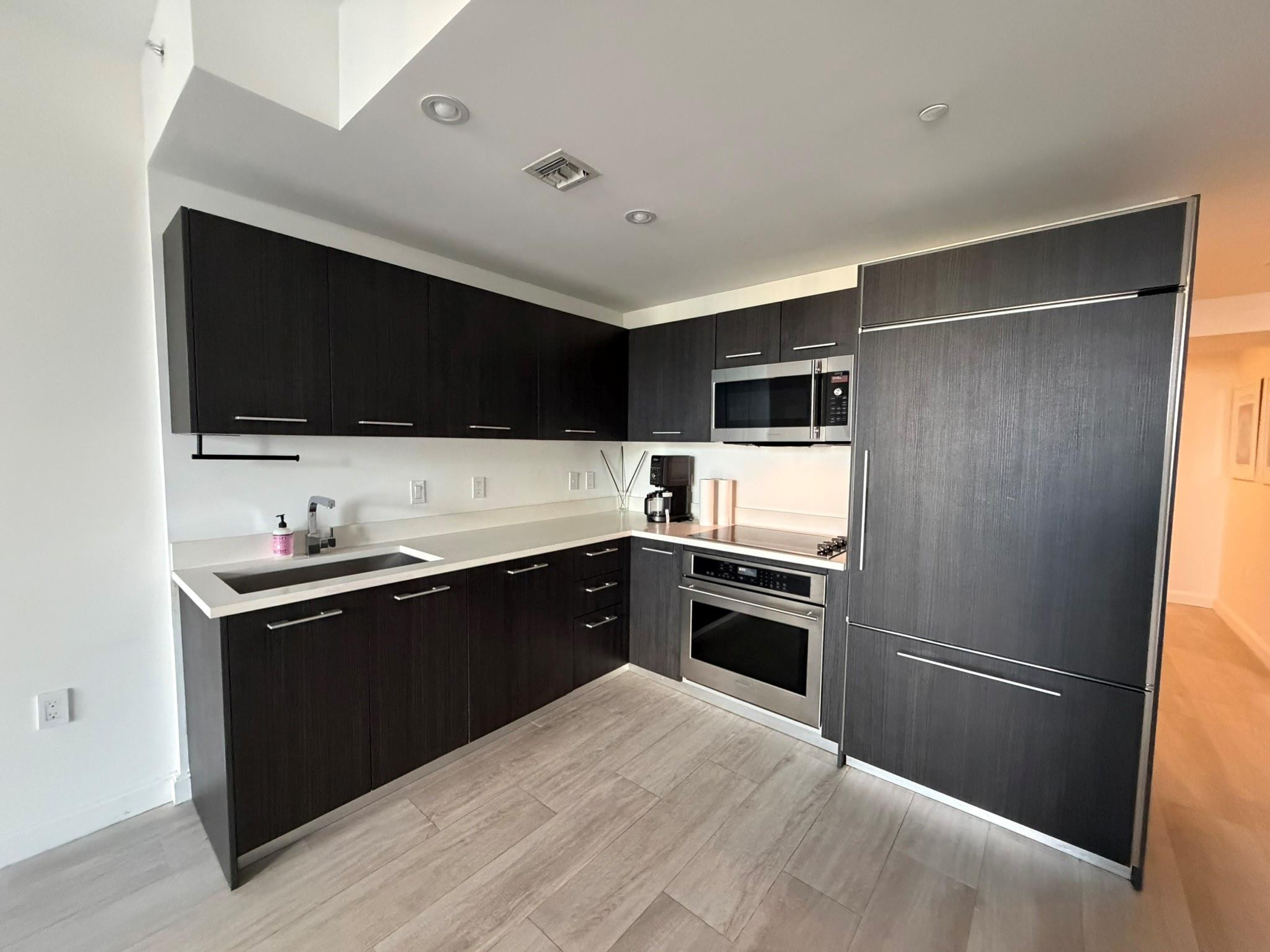 45 Southwest 9th Street, Unit 3110 Miami, FL 33130 - Photo 12 of 19 a kitchen with a refrigerator stove and microwave