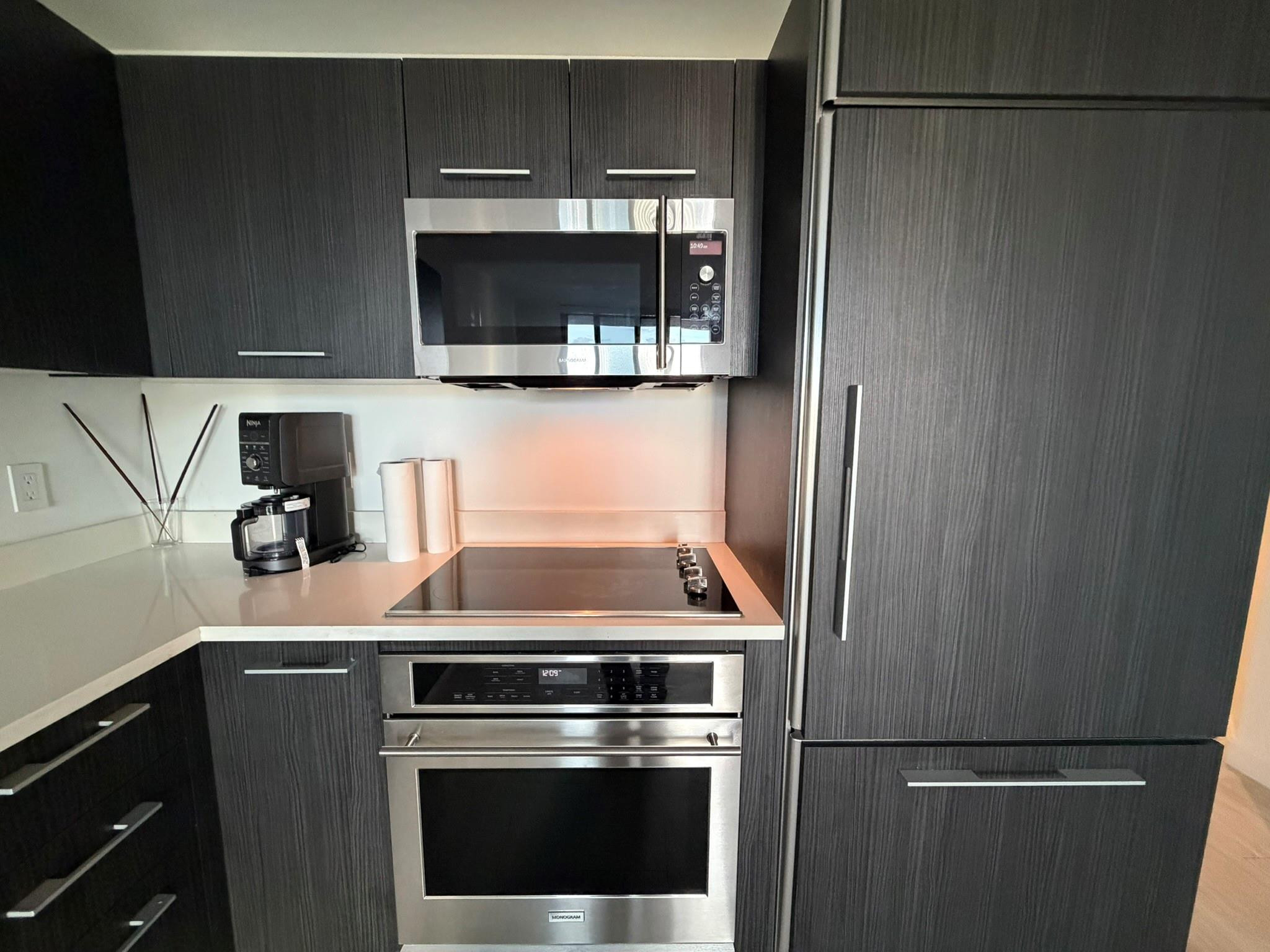 45 Southwest 9th Street, Unit 3110 Miami, FL 33130 - Photo 13 of 19 a kitchen with stainless steel appliances a refrigerator and a stove top oven