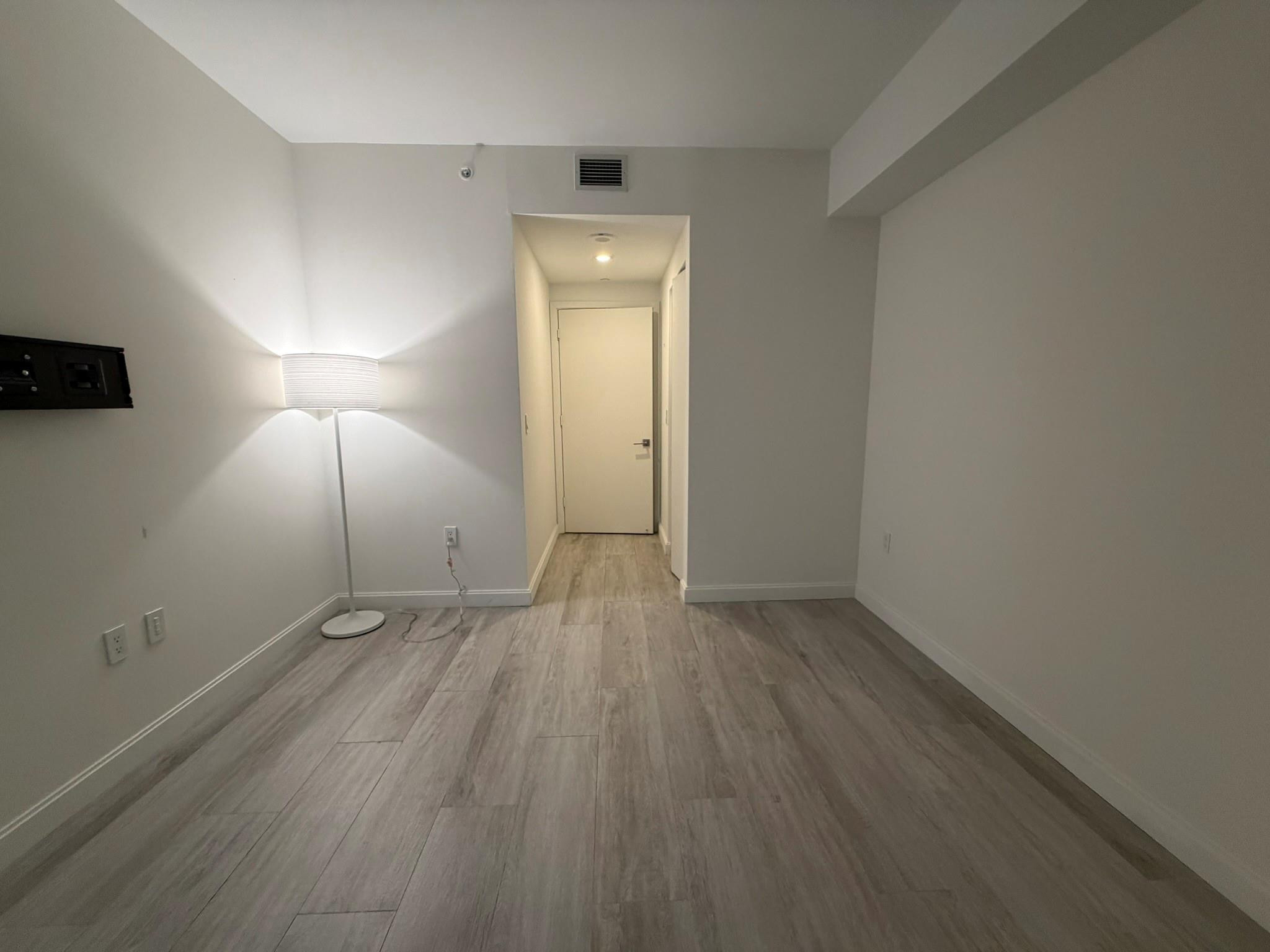 45 Southwest 9th Street, Unit 3110 Miami, FL 33130 - Photo 14 of 19 an empty room with wooden floor and windows