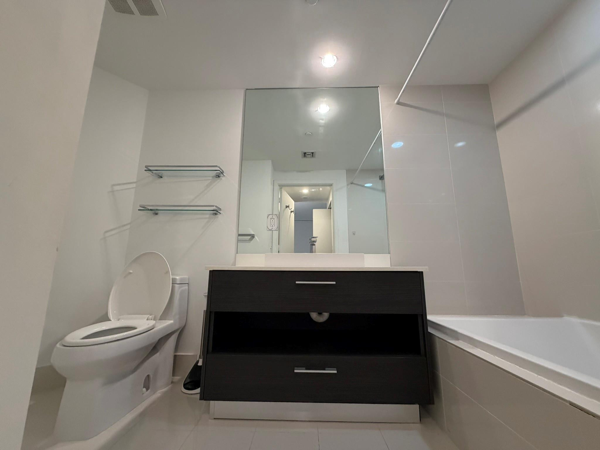 45 Southwest 9th Street, Unit 3110 Miami, FL 33130 - Photo 17 of 19 a bathroom with a sink and a mirror