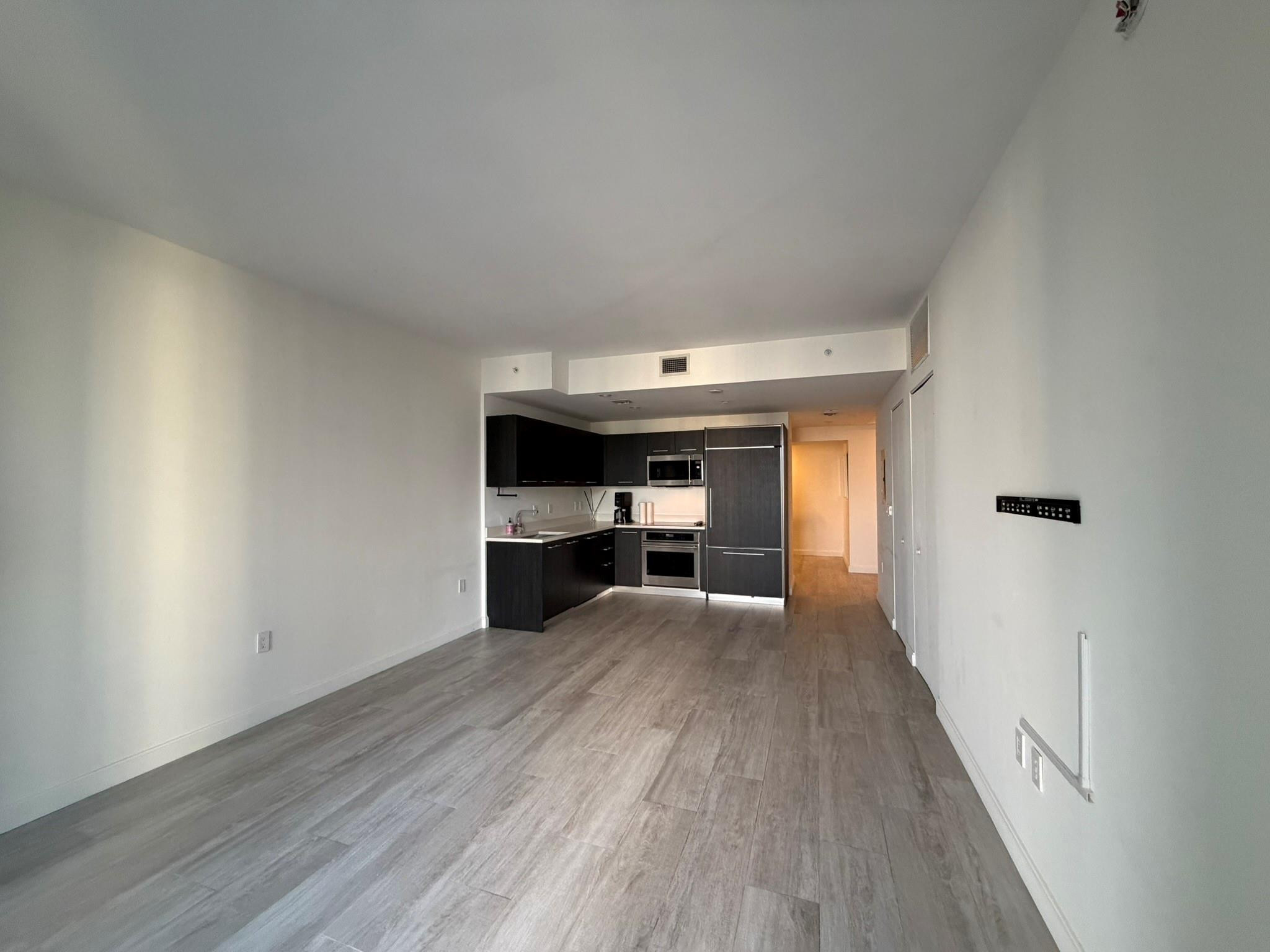 45 Southwest 9th Street, Unit 3110 Miami, FL 33130 - Photo 10 of 19 a view of empty room with wooden floor