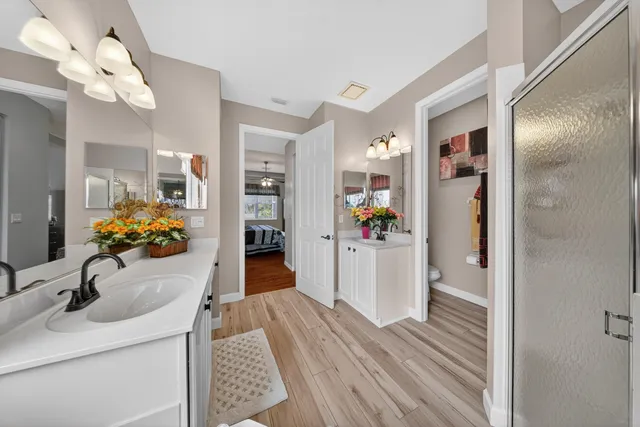 a hallway view with fireplace and wooden floor
