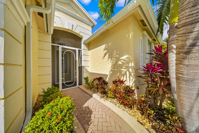 a vase of flowers sitting in front of a door