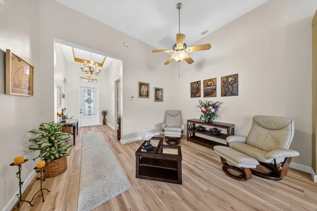 a living room with furniture and a chandelier