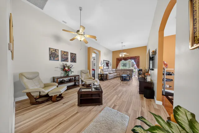 a living room with furniture or couch and a chandelier