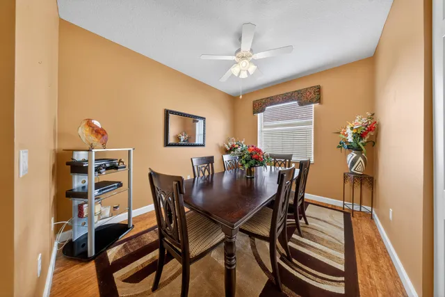 a view of a dining room with furniture and chandelier
