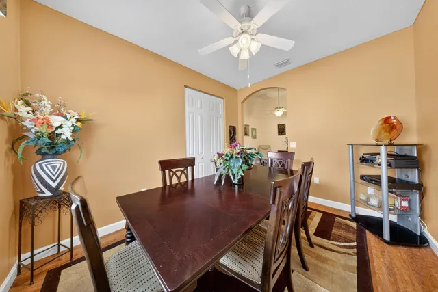 a view of a dining room with furniture and wooden floor