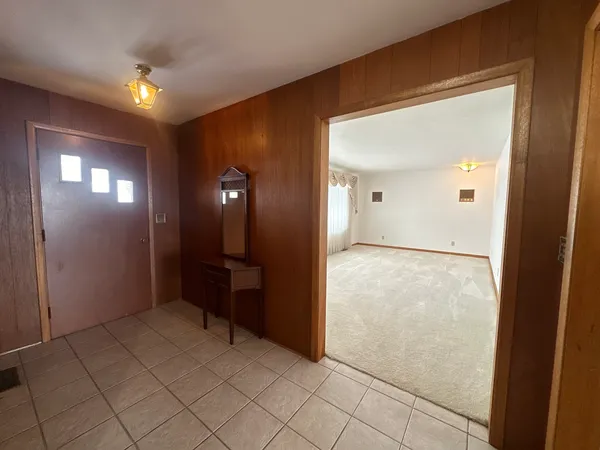 wooden floor in an empty room with a mirror