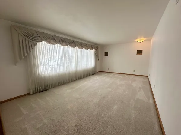a view of an empty room and a window
