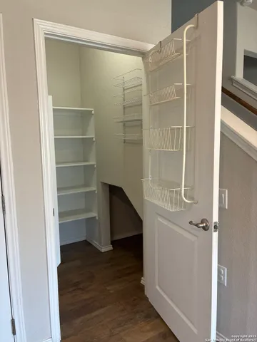 a view of walk in closet with empty racks