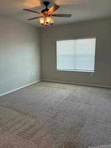 a view of a livingroom with a ceiling fan and window