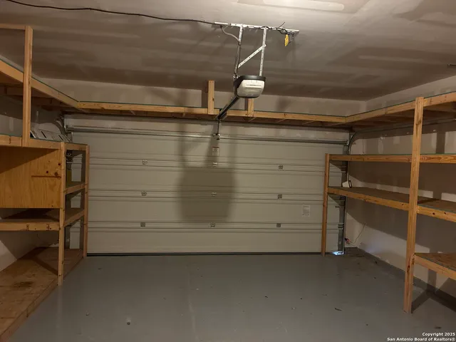 a view of an empty room with a ceiling fan and window