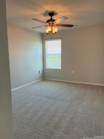 a view of a chandelier fan in a room