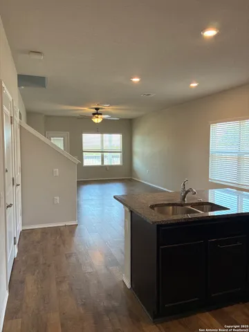 a kitchen with granite countertop a sink and a stove