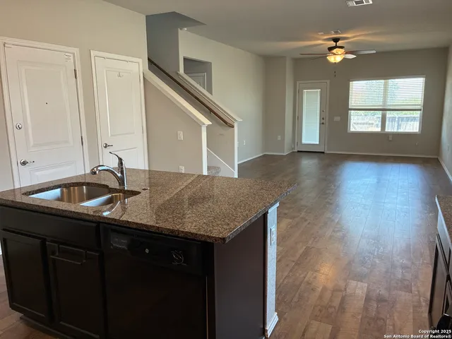a kitchen with a sink a stove and cabinets