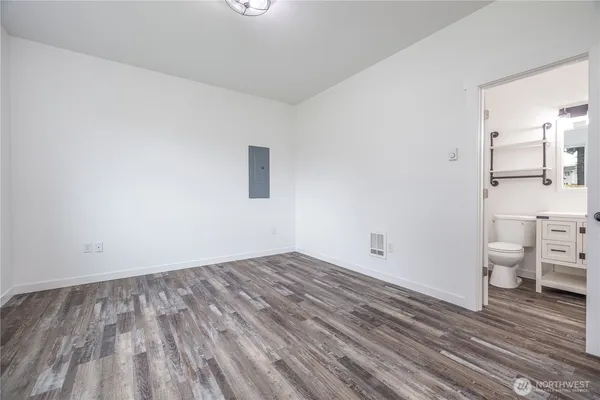 a view of empty room with wooden floor