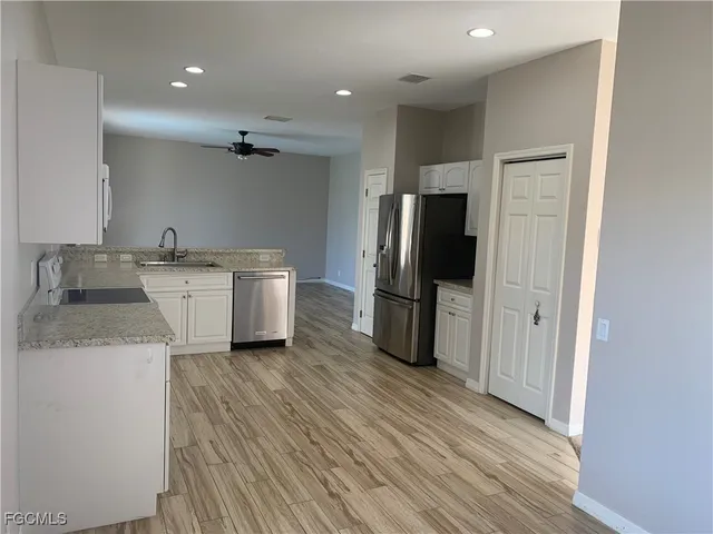 a kitchen with a sink stainless steel appliances and cabinets