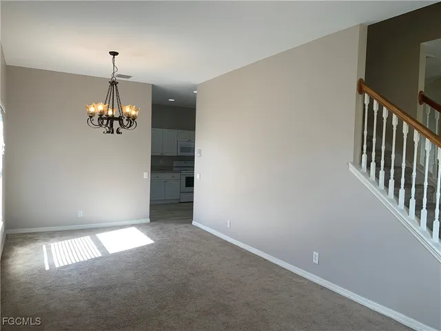 a furnished livingroom with window and stairs