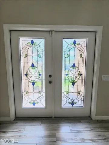 a view of front door and wooden floor