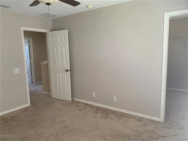 an empty room with a empty space and windows