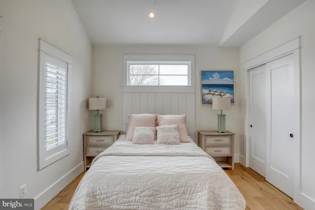 a bedroom with a bed and a mirror