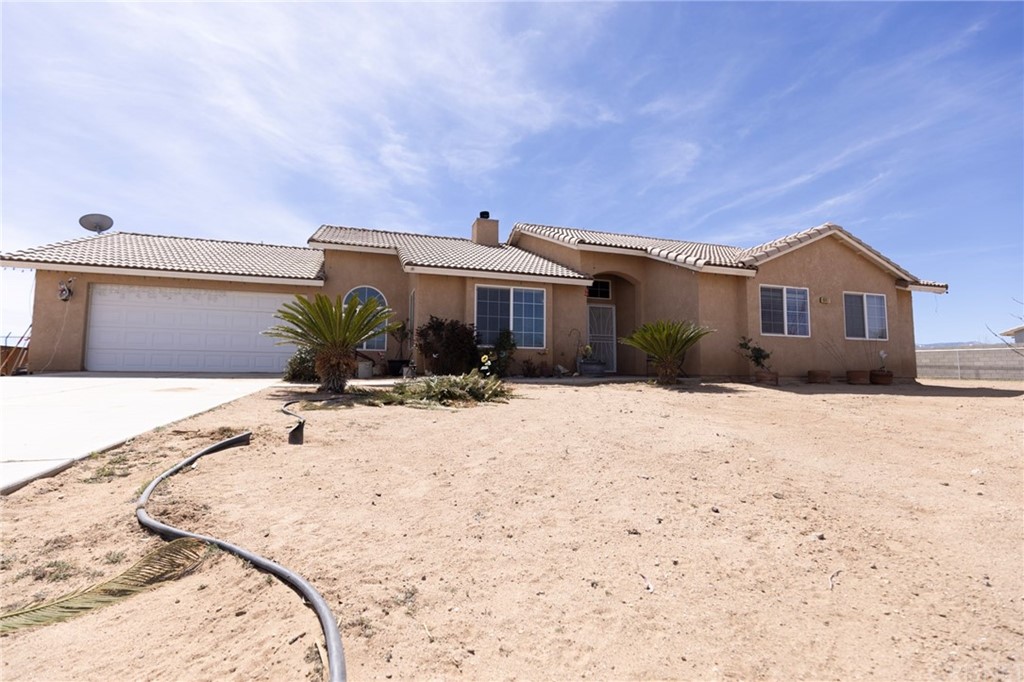 8867 Gorgonio Road Victorville, CA 92392 - Photo 1 of 1 a front view of a house with a yard