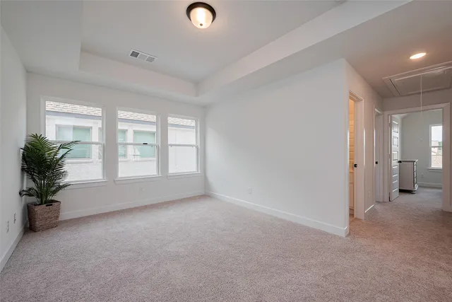 a spacious bedroom with a bed and a ceiling fan