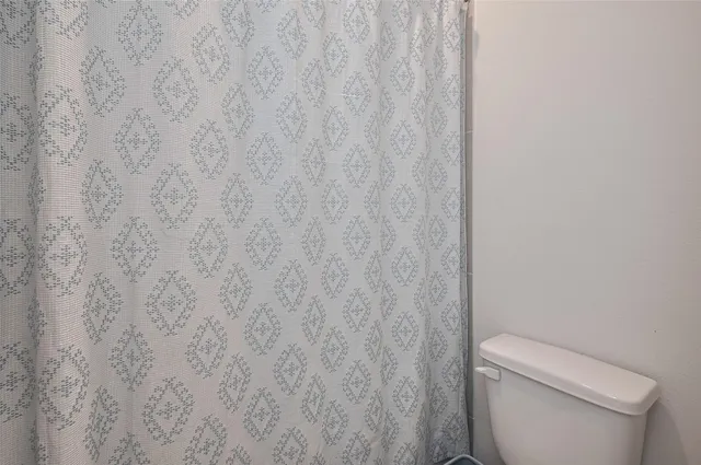 a view of walk in closet with clothes