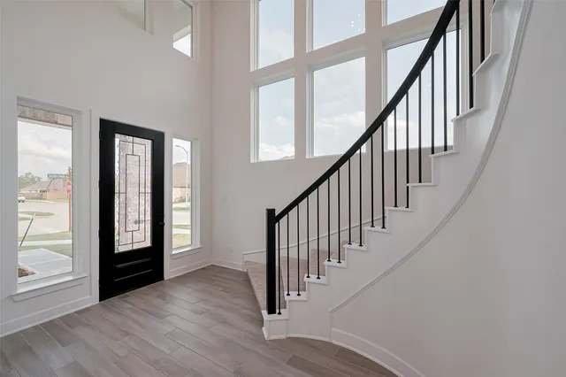 a view of entryway with wooden floor and chandelier