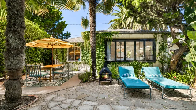 a view of patio with chairs and tables with potted plants